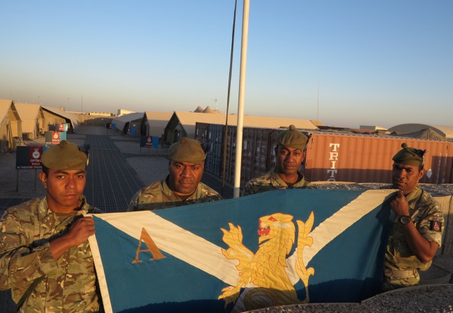 Raising the colours of the Royal Regiment of Scotland at their Camp Bastion base; from left “Highlander” Koni Fatiaki from Rotuma, Cpl Asaeli Saumaka from Tailevu, Drummer Lepani Secake from Tailevu, and Colour (Staff) Sgt Ilimo Dovibua who is the Company Quartermaster. - Ben Bohane, wakaphotos.com