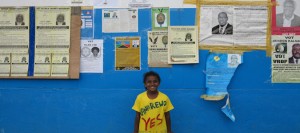 From the Vanuatu election blog: A young political supporter poses with campaign posters in Port Vila.